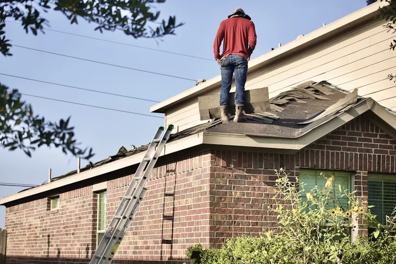 Professional roofer working on a residential roof in Oak Lane Manor